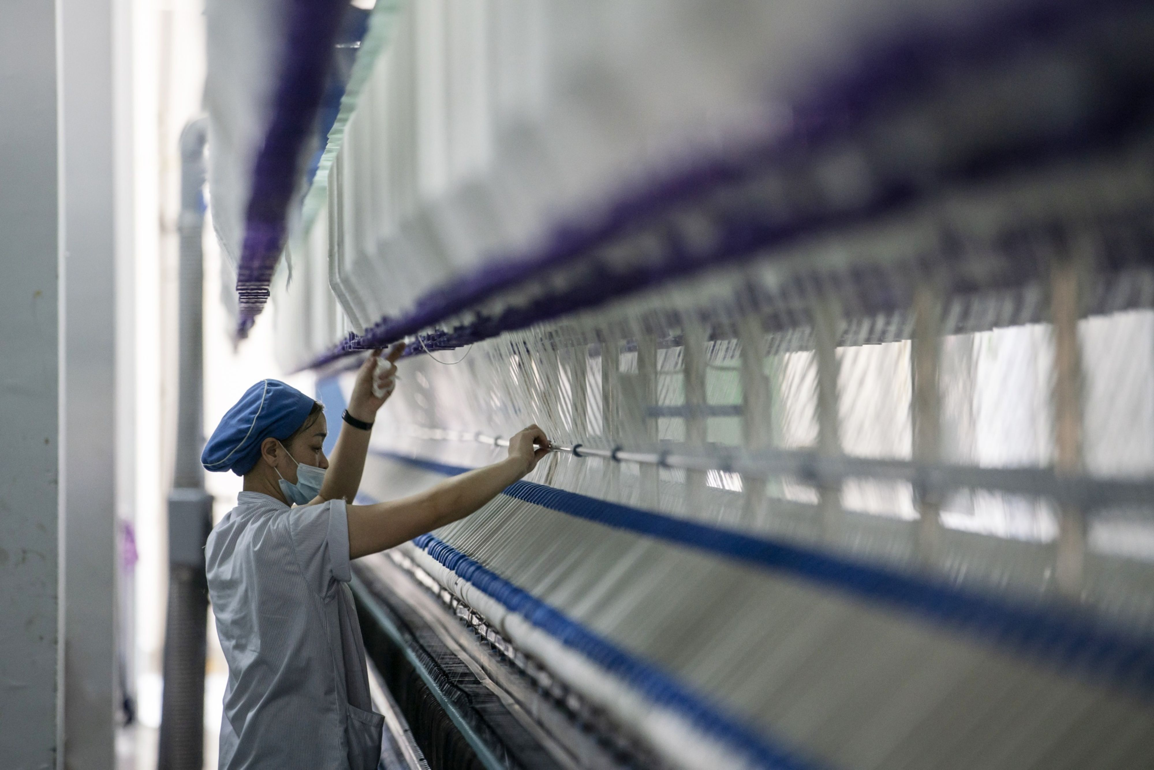 Inside a Textile Factory As China's Factories Roll on, Upending New Years Spending Patterns