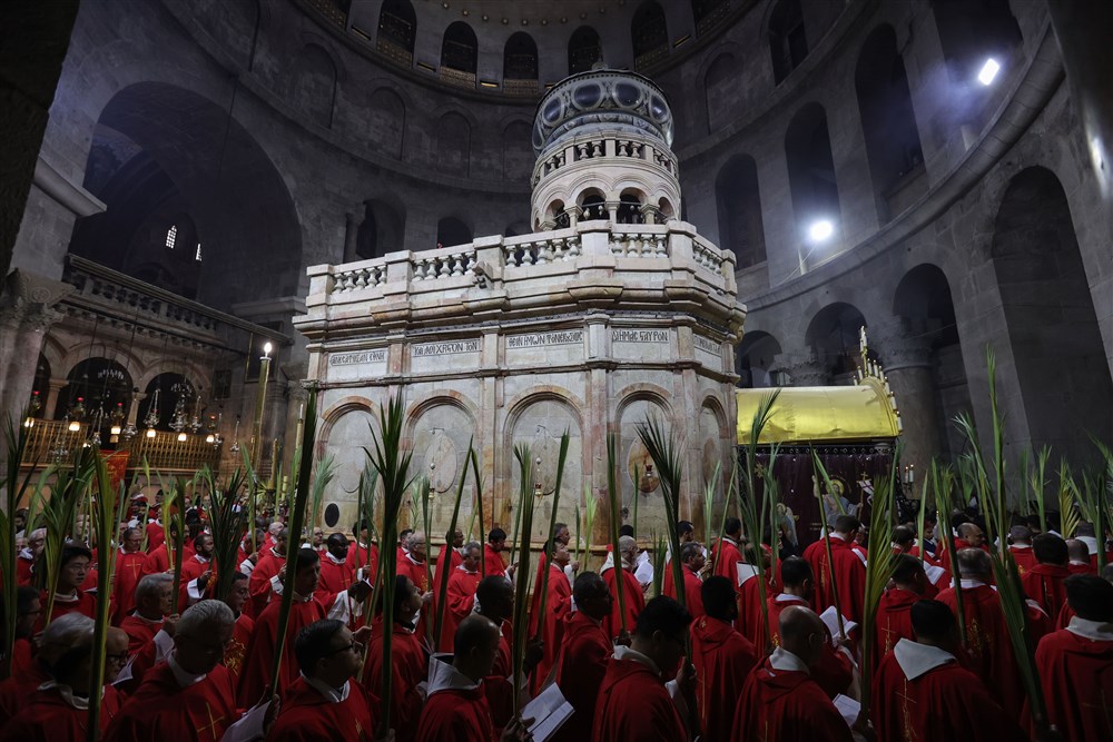 Catholic clergymen carry palm branches during the Palm Sunday procession at the Church of the Holy Sepulchre in the Old City of Jerusalem, 02 April 2023. Palm Sunday for Roman Catholic devotees symbolically marks the biblical account of the entry of Jesus Christ into Jerusalem, signaling the start of the Holy Week.  EPA-EFE/ABIR SULTAN