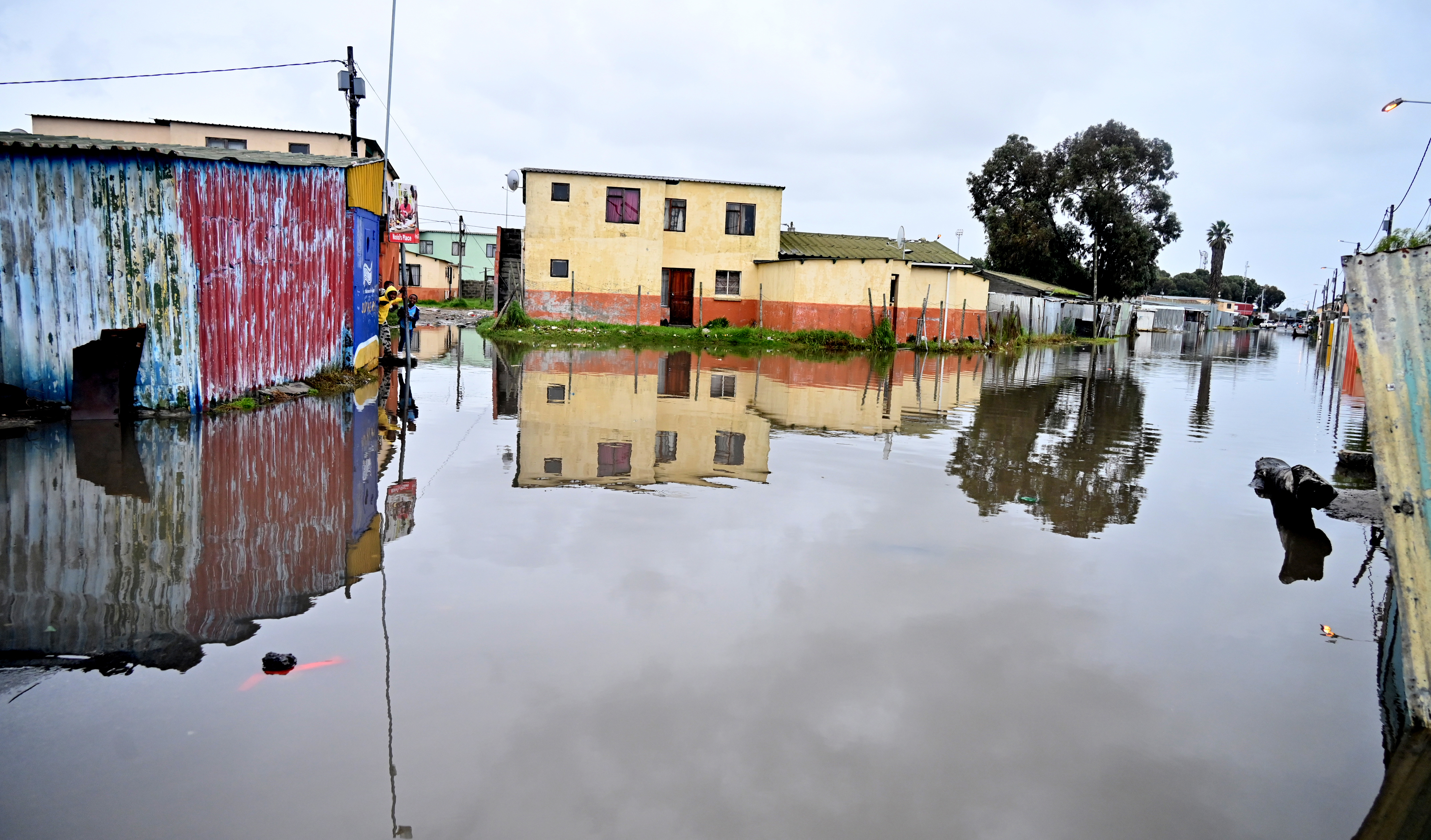 Roads, rail, power and homes disrupted as torrential rain and winds batter Cape Town and surrounds