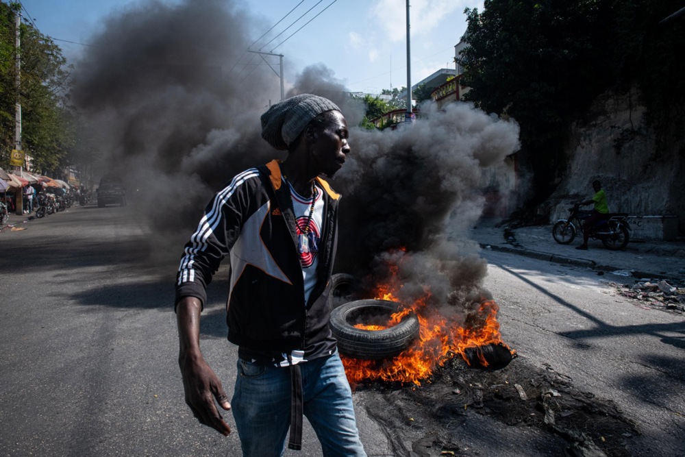 Demonstrators set tires on fire during a protest in Port-au-Prince, Haiti, 12 March 2024. According to a statement by the Caribbean Community and Common Market (CARICOM) regional bloc on 11 March, Haiti's Prime Minister Ariel Henry announced his government would resign after the establishment of a transitional presidential council and the appointment of a new interim prime minister. Henry's resignation comes following weeks of crisis and gang violence in the country.  EPA-EFE/Johnson Sabin