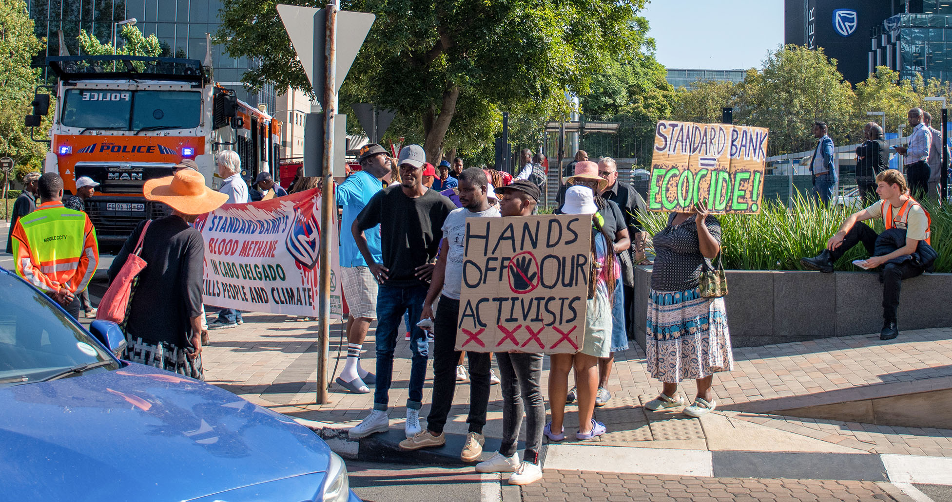 Climate activists stand in solidarity after arrests outside Standard Bank