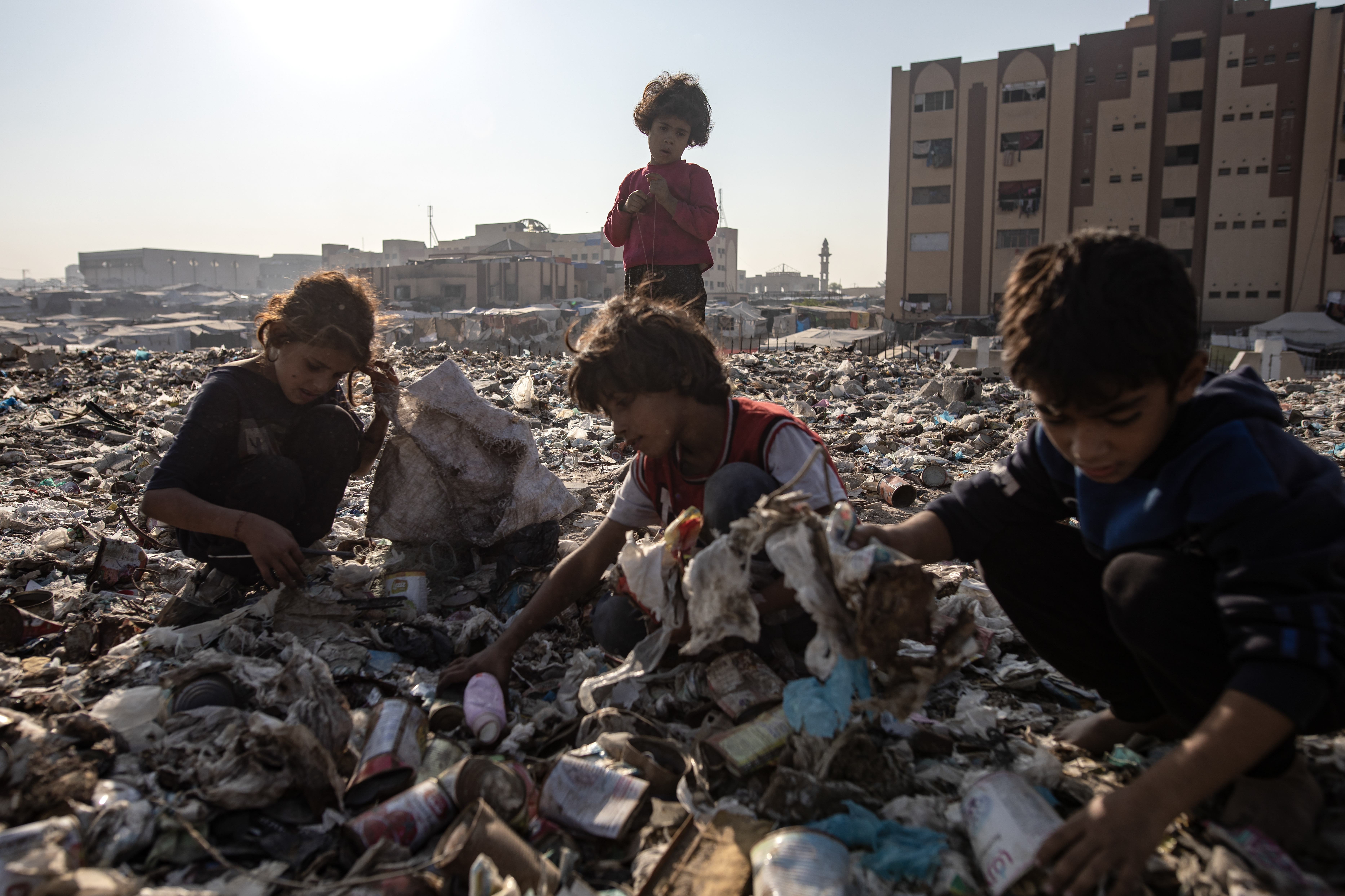Palestinian children collect garbage amid cooking gas and fuel shortage