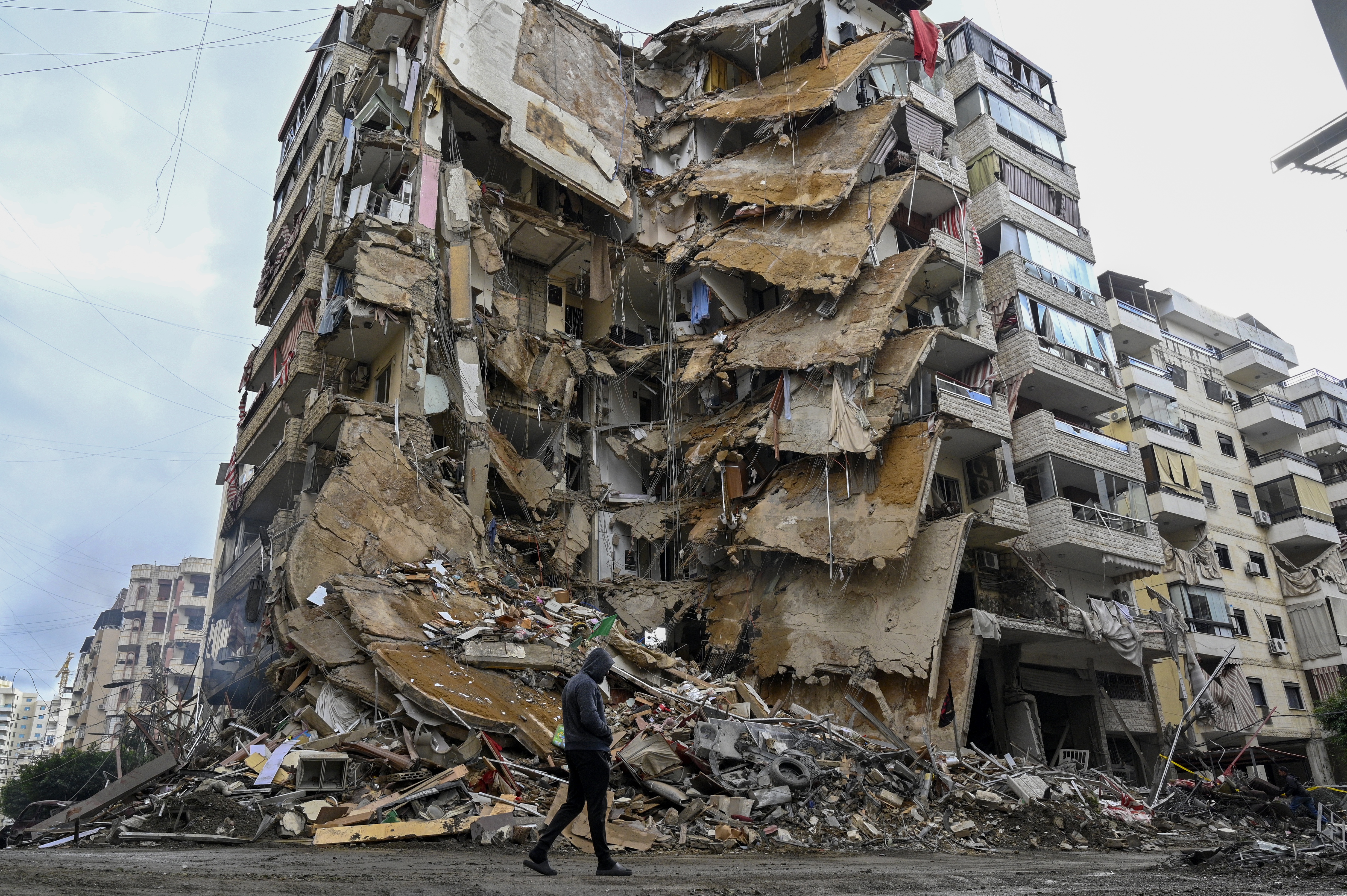People check damaged buildings after Israeli military strikes on Beirut