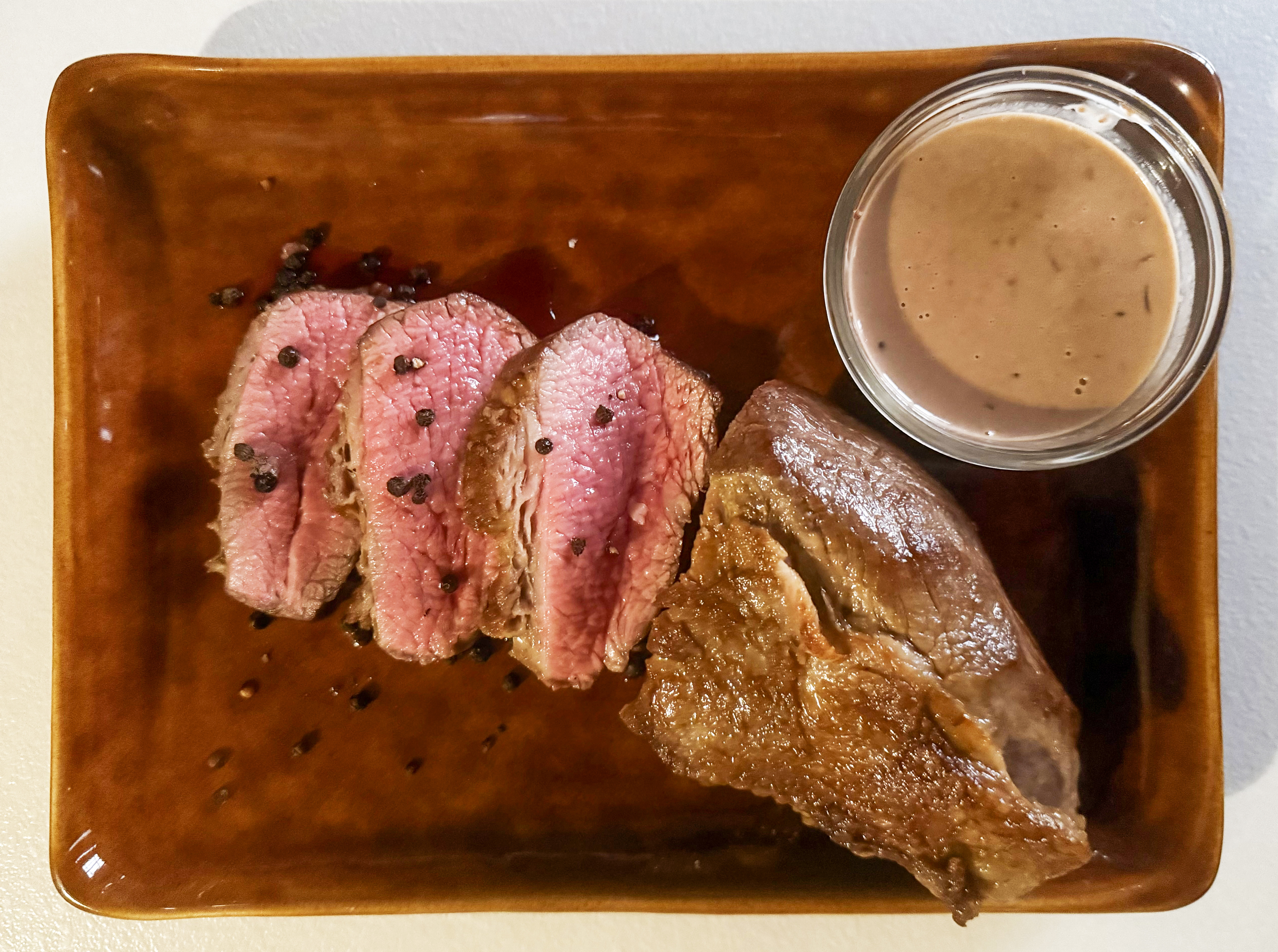 Pan-fried rumptail with creamy peppercorn and Port sauce