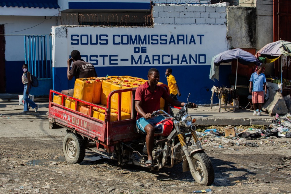 A man carries water cans at Poste Marcharnd in Port-au-Prince, Haiti, 11 March 2025. One year after Ariel Henry announced his resignation as prime minister, Haiti is at a standstill.  EPA-EFE/Mentor David Lorens