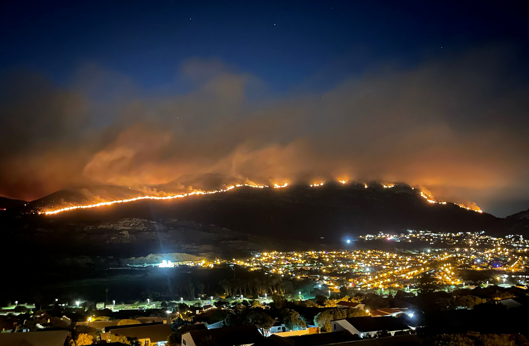 Arson suspect arrested as firefighters continue to battle blazes in the south of Cape Town
