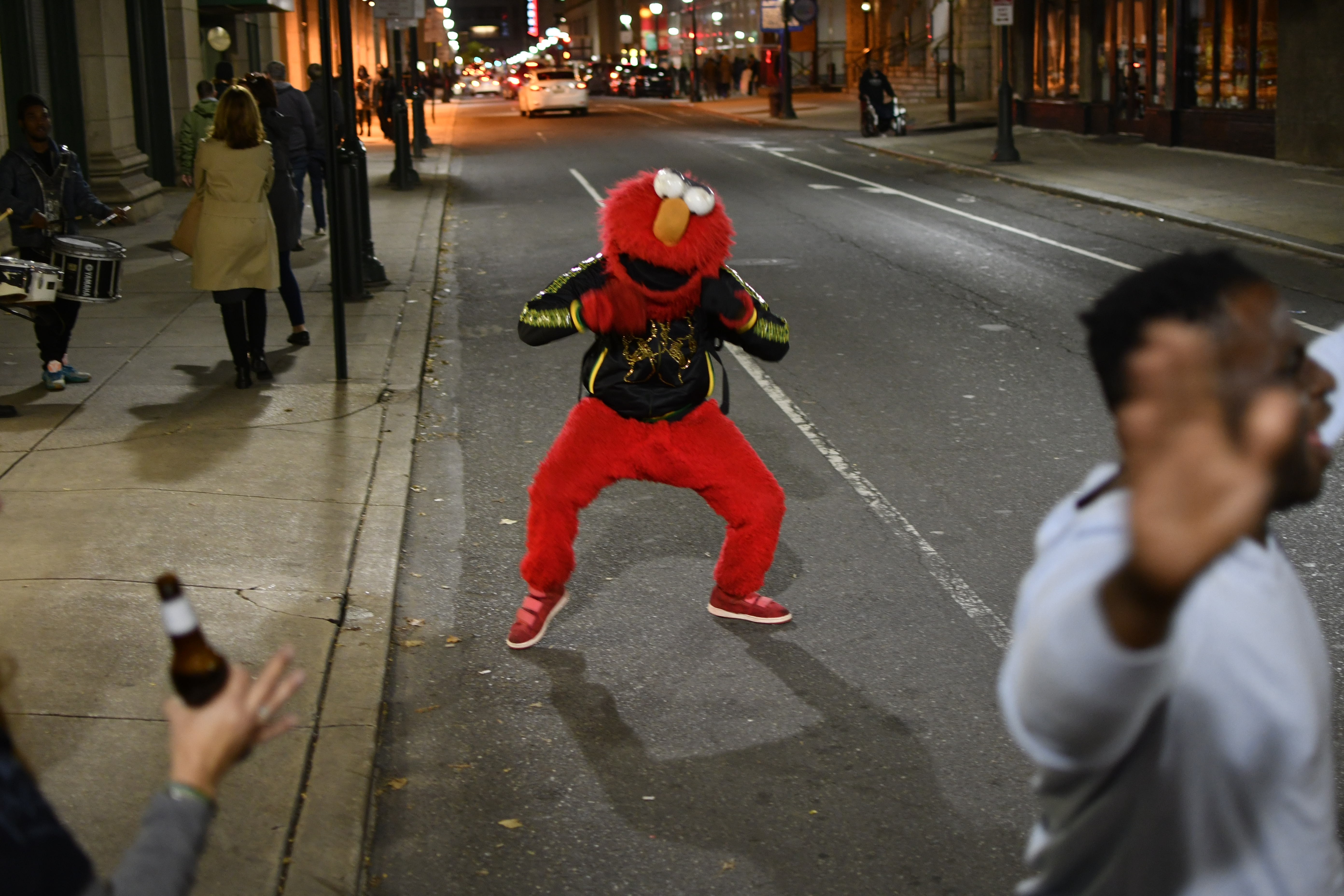 epa07140362 A person in an Elmo costume is seen dancing on the street as Governor Tom Wolf, Senator Bob Casey and Lieutenant Governor candidate John Fetterman visit the LGTBQ bar Woody's during a state wide bus tour to camping for the reelection of Wolf and Casey, in Philadelphia, Pennsylvania, USA, 03 November 2018. Wolf faces a challenge from Businessman Scott Wagner and Senator Casey is challenged by Representative Lou Barletta in the 06 November general election.  EPA/BASTIAAN SLABBERS