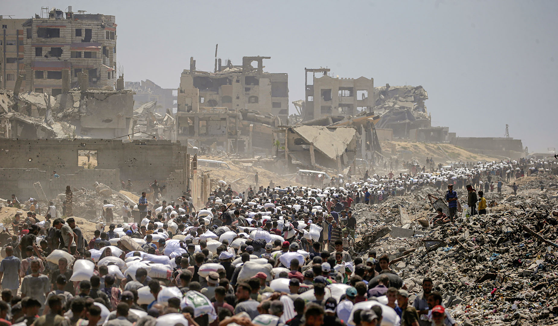 Gazans stream towards wrecked homes as Israeli forces pull back under ceasefire