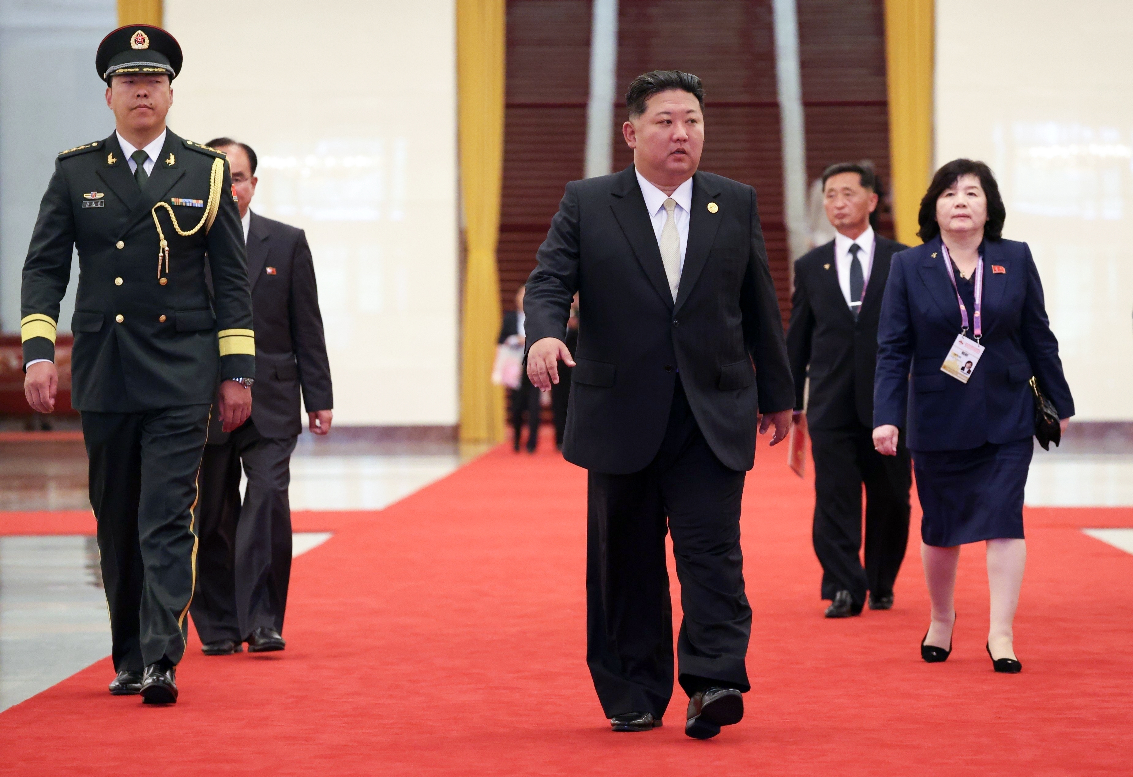 North Korea's Kim and South Korean parliament speaker shake hands in Beijing