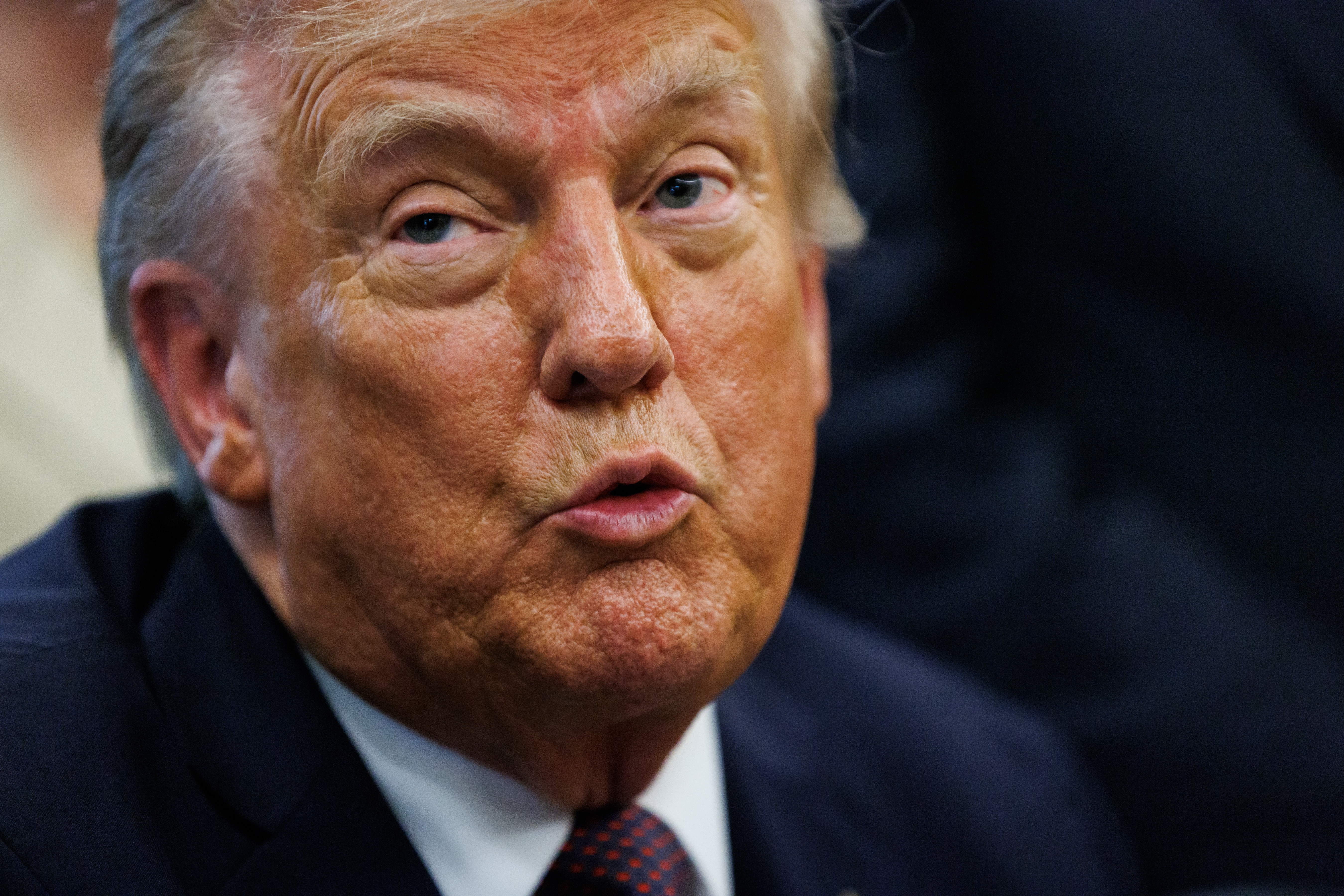 US President Trump signs a Presidential Memorandum in the Oval Office