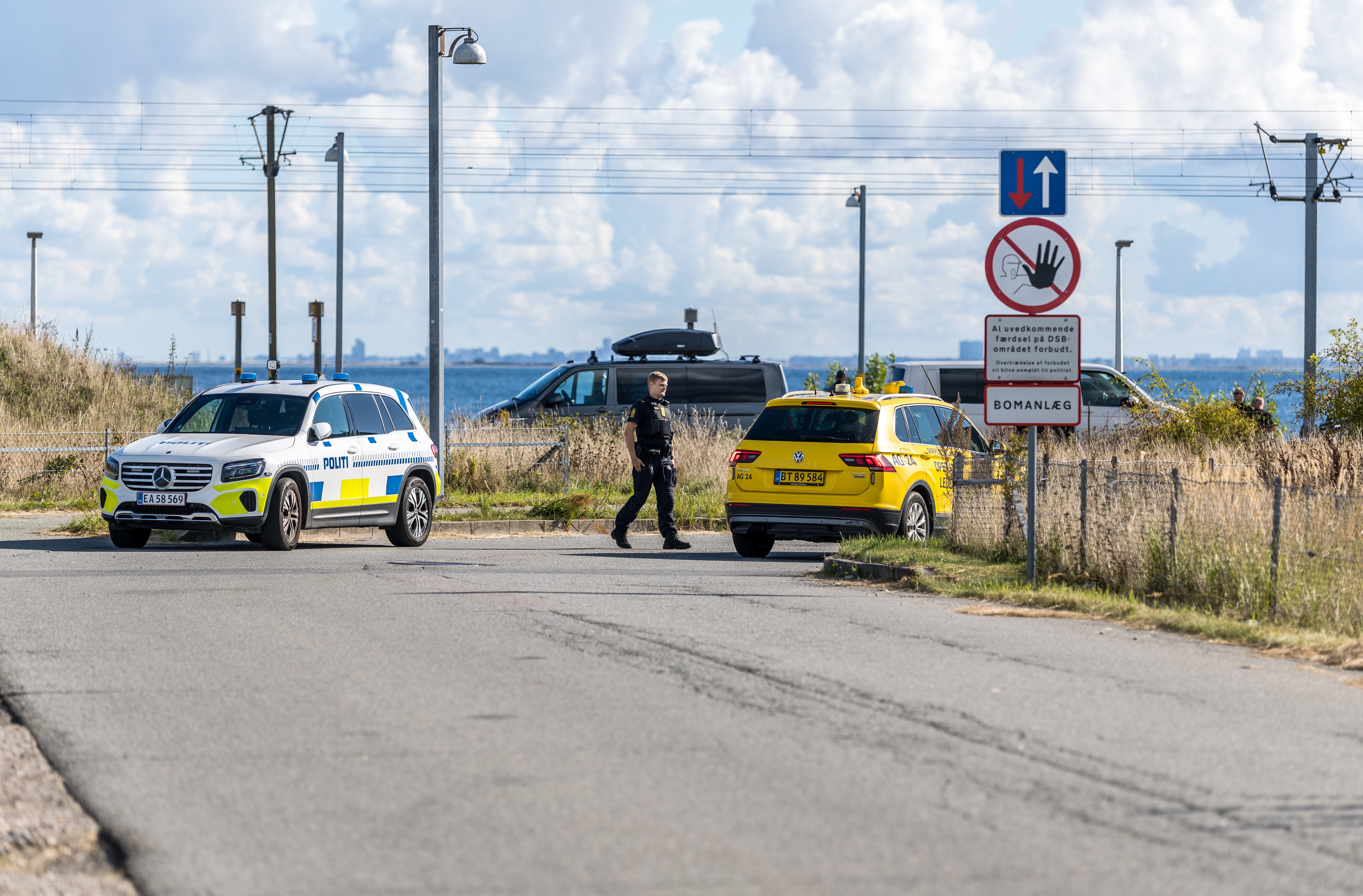 Police inspect an area after drone sightings at Copenhagen Airport