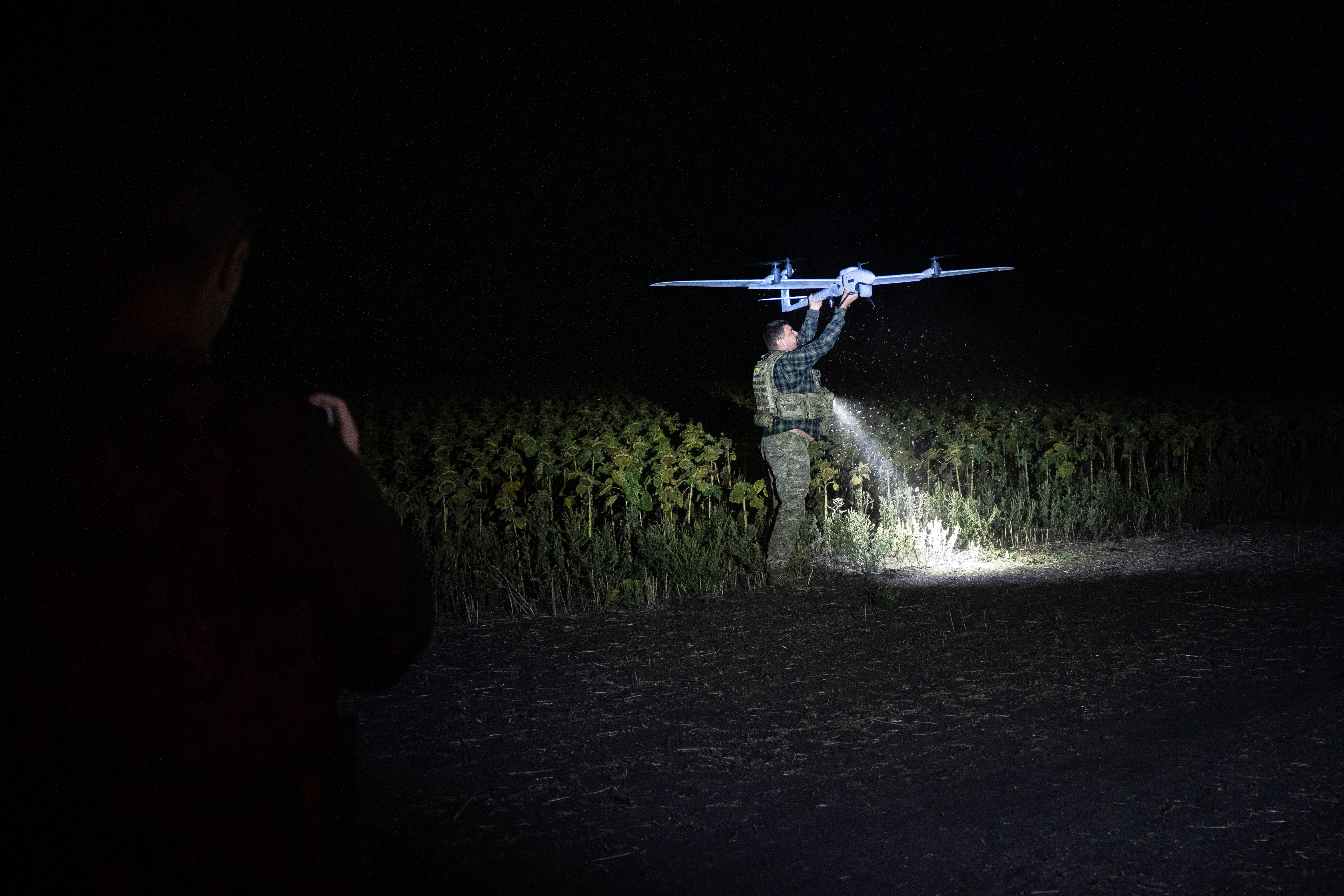 A member of the 1st Special Purpose "Safari" Assault Police Regiment of the Ukrainian National Police handles an American-made 'Vector' reconnaissance drone during a mission to look for Russian forces and logistical facilities on September 11, 2025 in the Donetsk region of Ukraine. (Photo by Ximena Borrazás/Getty Images)