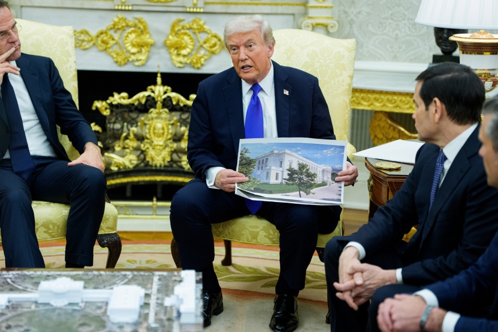 US President Donald J. Trump holds a mock-up of the new White House Ballroom as he meets with NATO Secretary General Mark Rutte in the Oval Office of the White House in Washington, DC, USA, 22 October 2025. The leaders met to discuss continued support for Ukraine.  EPA/AARON SCHWARTZ / POOL