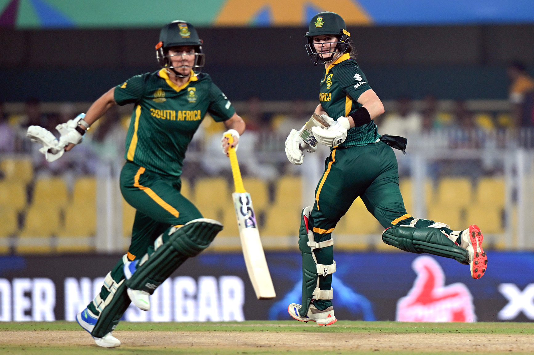 Laura Wolvaardt (right) runs between the wicket with teammate Marizanne Kapp. (Photo: Prakash Singh / Getty Images)