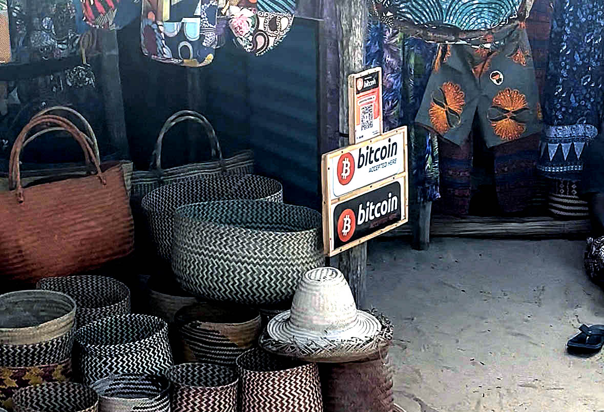 A sign advertising Bitcoin as an accepted form of payment at the local markets in Tofo, Mozambique. (Photo: Kara le Roux)