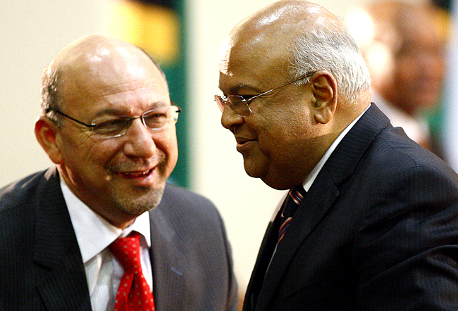 Former tax authority chief Gordhan talks with Manuel after Gordhan was sworn in as the new finance minister at the presidential guest house in Pretoria