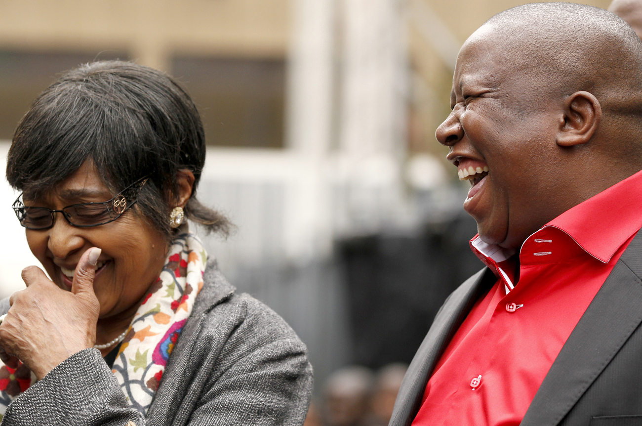 African National Congress Youth League president Julius Malema shares a joke with Winnie Madikizela-Mandela, former wife of Nelson Mandela, during Malema's appearance at the Johannesburg court