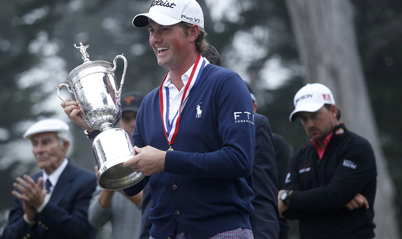 Webb Simpson of the U.S. holds the the U.S. Open Championship Trophy as Northern Ireland's Graeme McDowell (R) looks on after Simpson the 2012 U.S. Open golf tournament on the Lake Course at the Olympic Club in San Francisco
