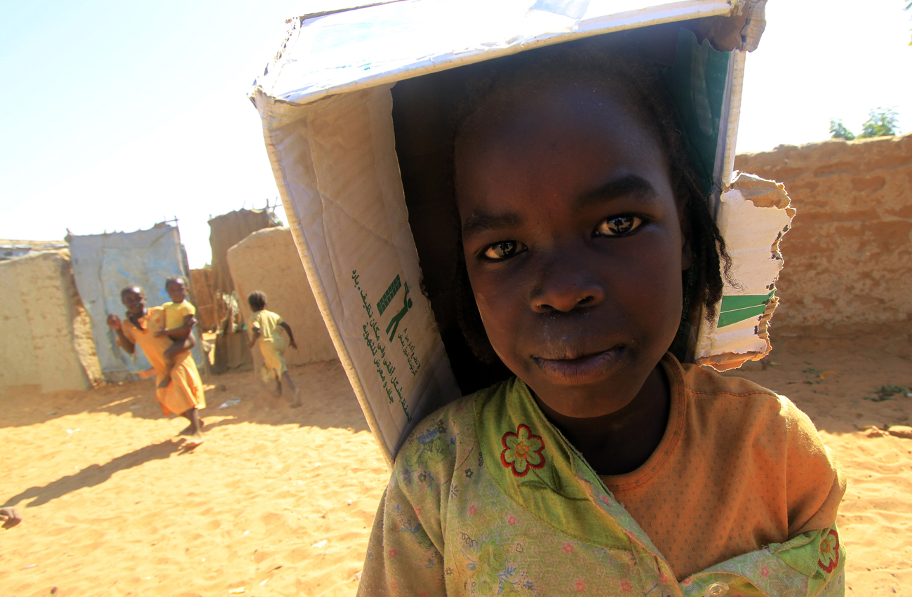 An internally displaced girl looks on at the Abu Shouk camp near El Fasher