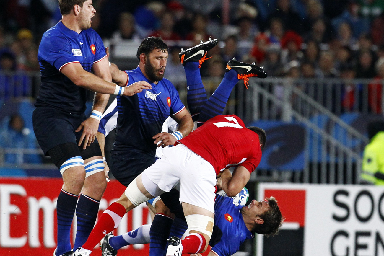 Wales captain Sam Warburton makes an illegal tackle on France's Vincent Clerc during their Rugby World Cup semi-final match at Eden Park in Auckland