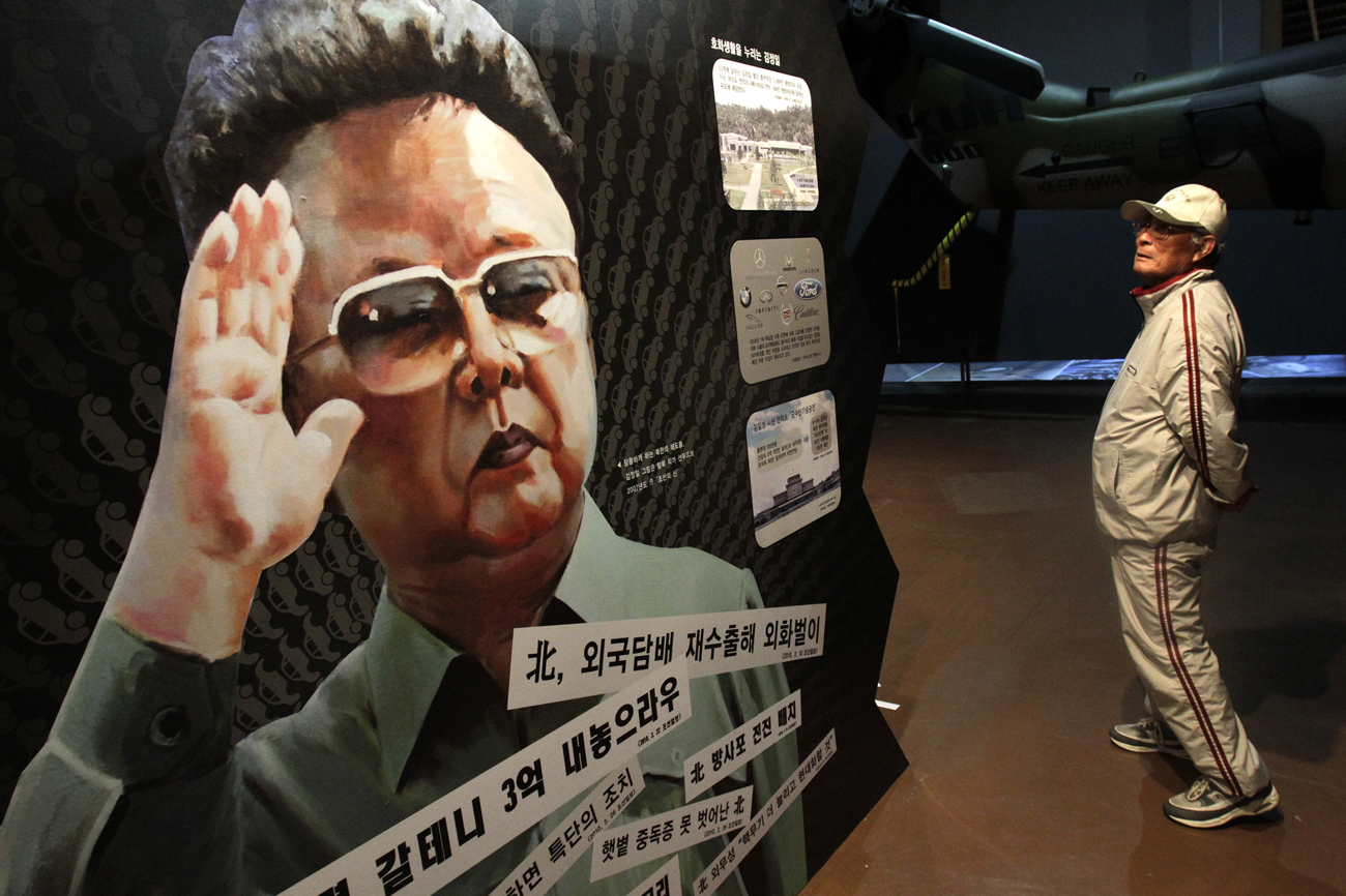 A man looks at a portrait of North Korean leader Kim Jong-il during the Korean War exhibition at the Korean War Memorial Museum in Seoul
