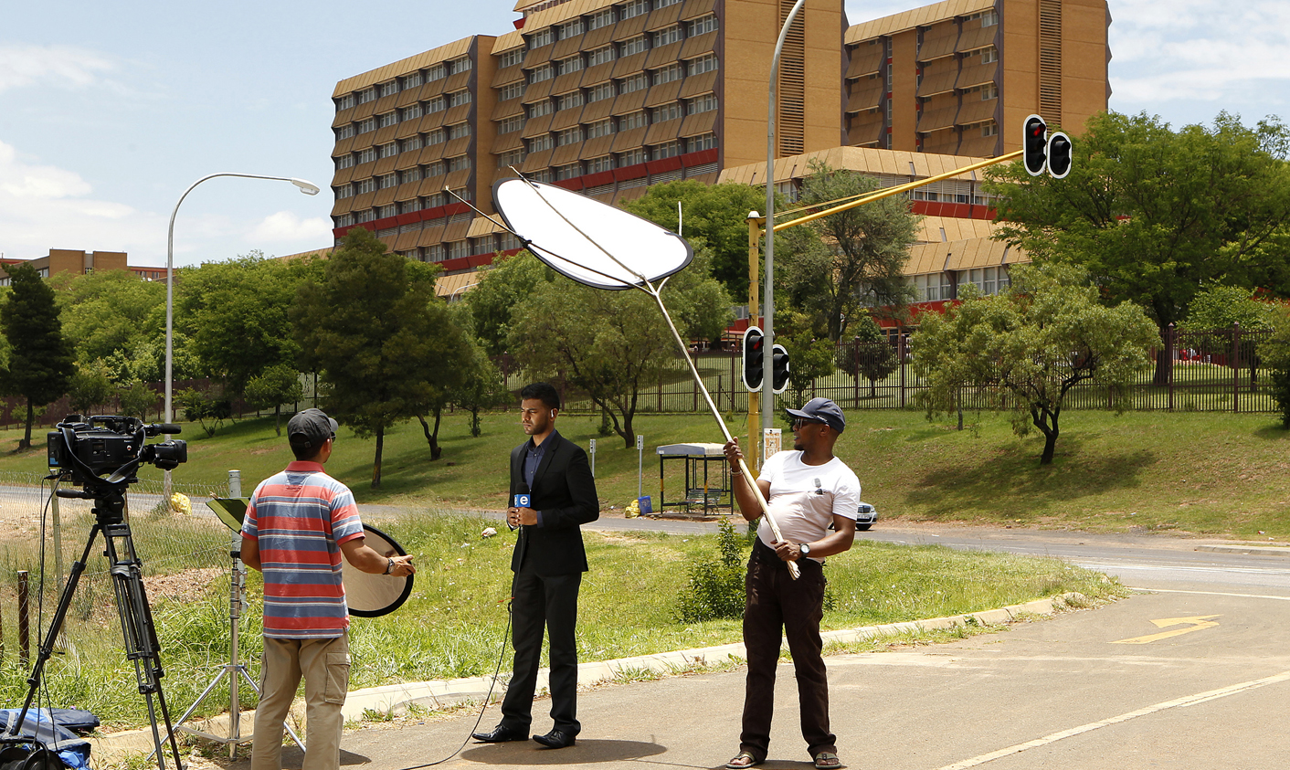 A television crew films outside a military hospital in Pretoria