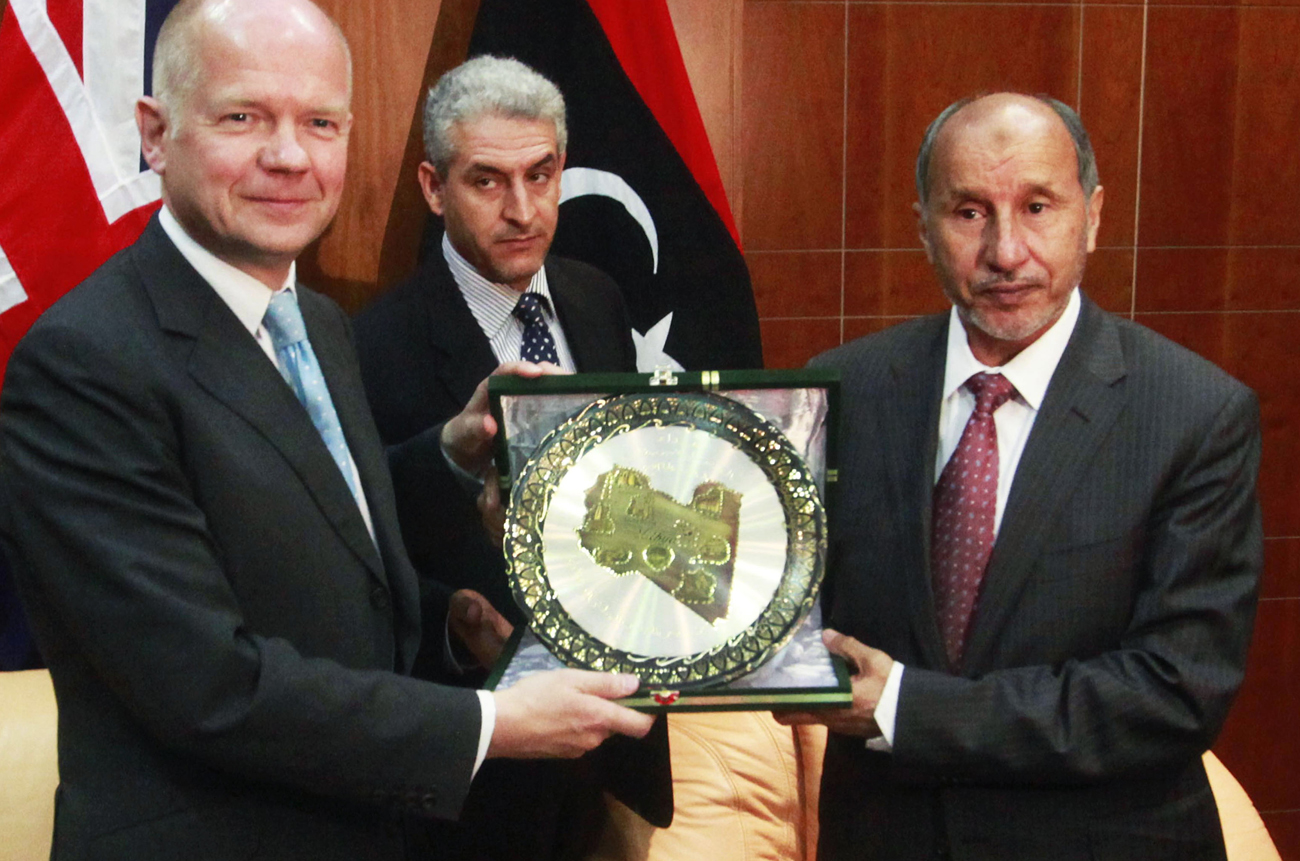 British Foreign Secretary Hague receives a gift from Chairman of Libya's National Transitional Council Jalil after their meeting in Tripoli