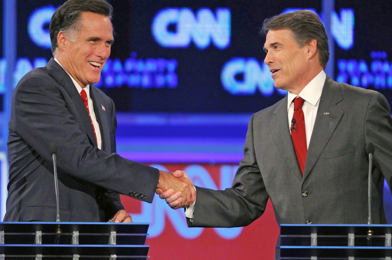 Romney (L) and Texas Governor Rick Perry shake hands at the conclusion of the CNN/Tea Party Republican presidential candidates debate in Tampa