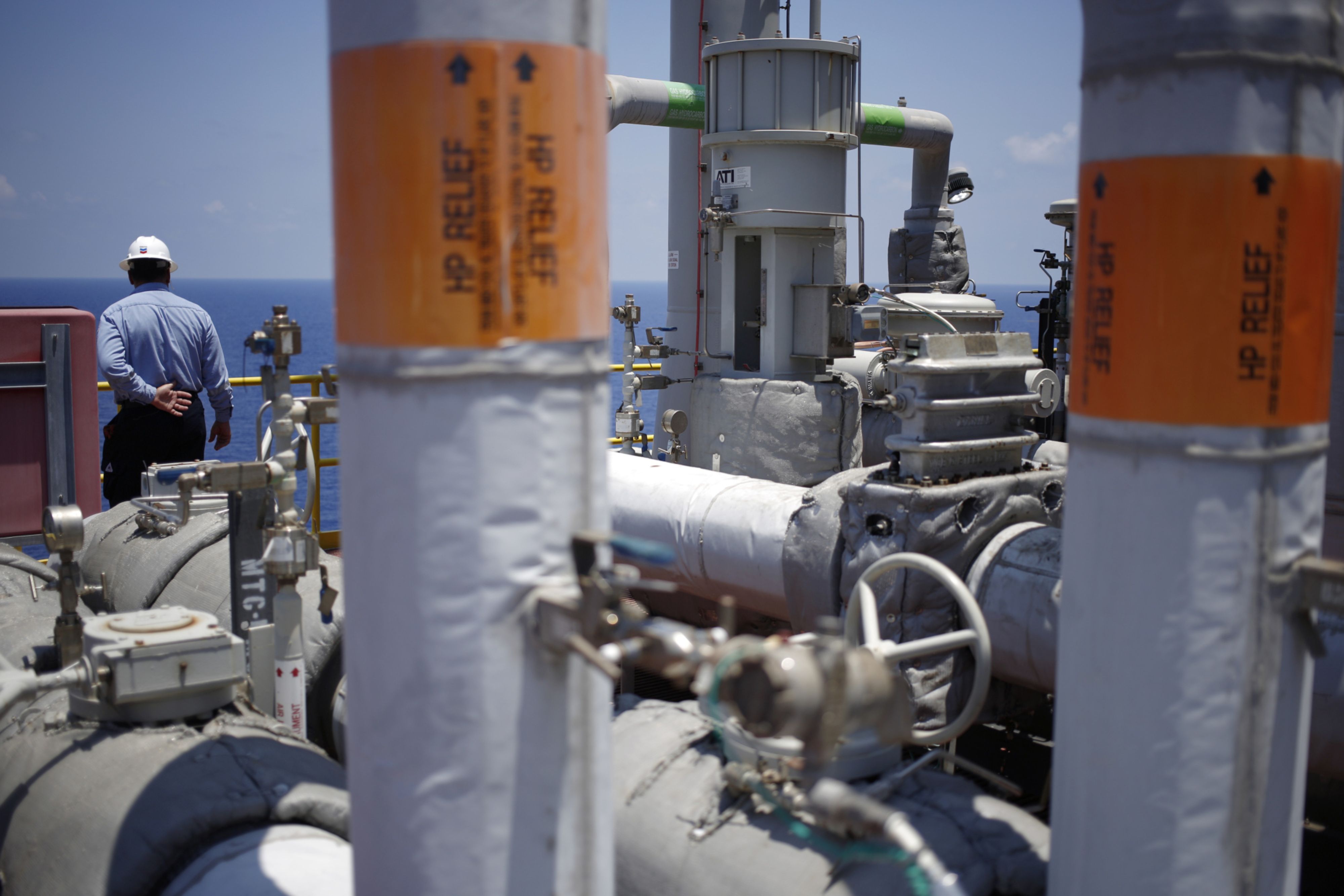 An offshore worker stands aboard the Chevron Corp. Jack/St. Malo deepwater oil platform in the Gulf of Mexico off the coast of Louisiana, U.S., on Friday, May 18, 2018. While U.S. shale production has been dominating markets, a quiet revolution has been taking place offshore. The combination of new technology and smarter design will end much of the overspending that's made large troves of subsea oil barely profitable to produce, industry executives say. Photographer: Luke Sharrett/Bloomberg
