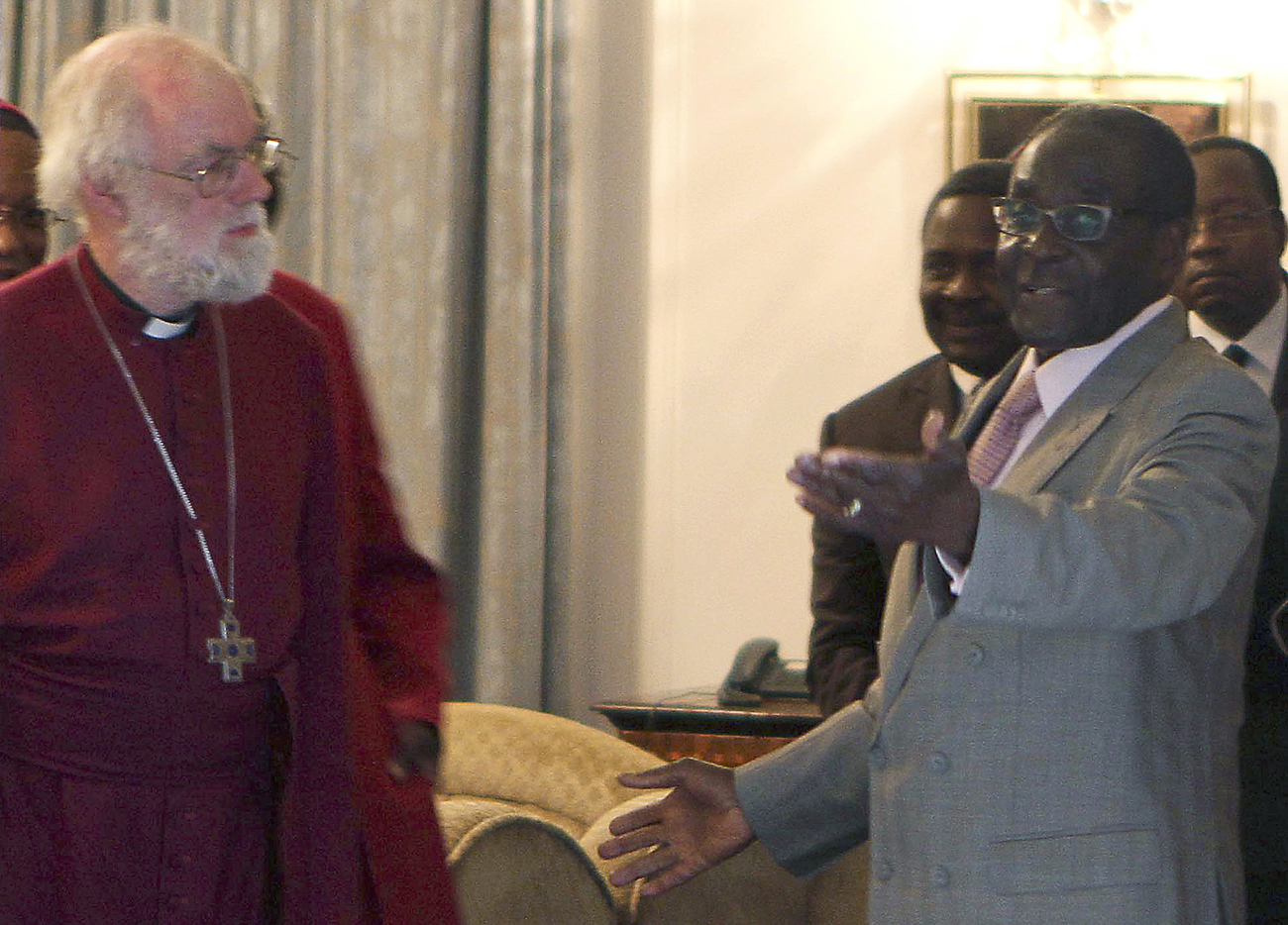 Zimbabwe's President Robert Mugabe welcomes the Archbishop of Canterbury Rowan Williams for a meeting at the State House in Harare