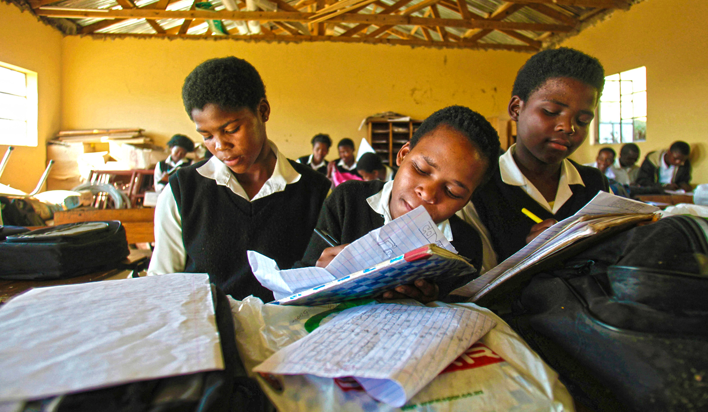Children write notes from a makeshift black board at a school in Mwezeni village in South Africa's Eastern Cape Province