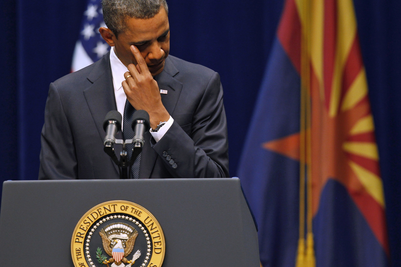 Obama wipes his eye as he addresses the crowd at the "Together We Thrive: Tucson and America" event in Tucson