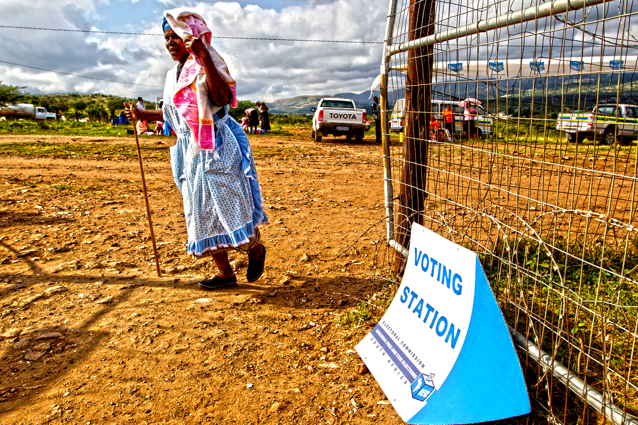 Woman arrives at polling station during South African municipal elections in Nkandla