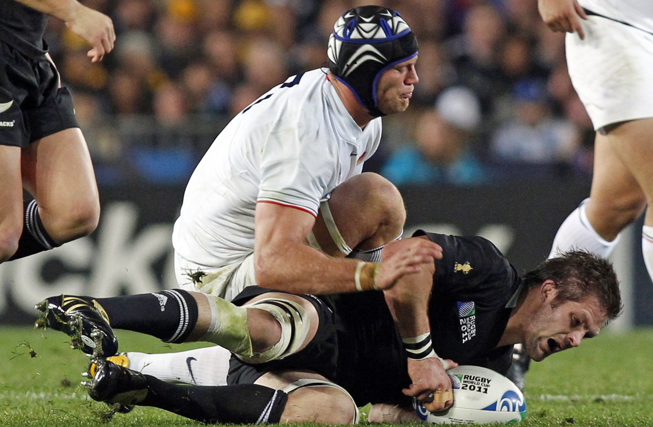 France's Julien Bonnaire tackles New Zealand All Blacks captain Richie McCaw during their Rugby World Cup Pool A match at Eden Park in Auckland