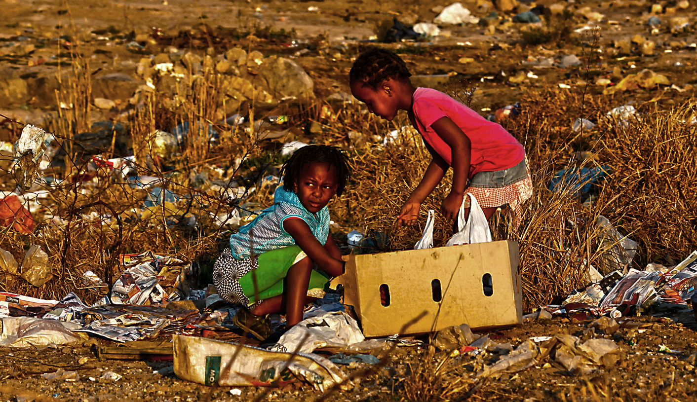 Children play at a rubbish dump at an informal settlement in Soweto
