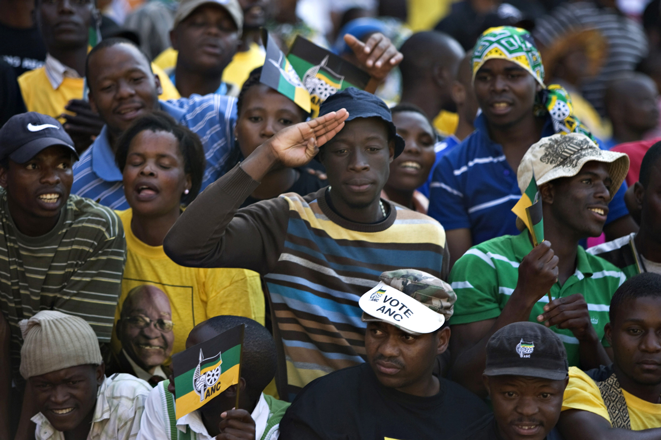 A supporter salutes as Nelson Mandela leaves the final election rally for the ruling African National Congress party in Johannesburg