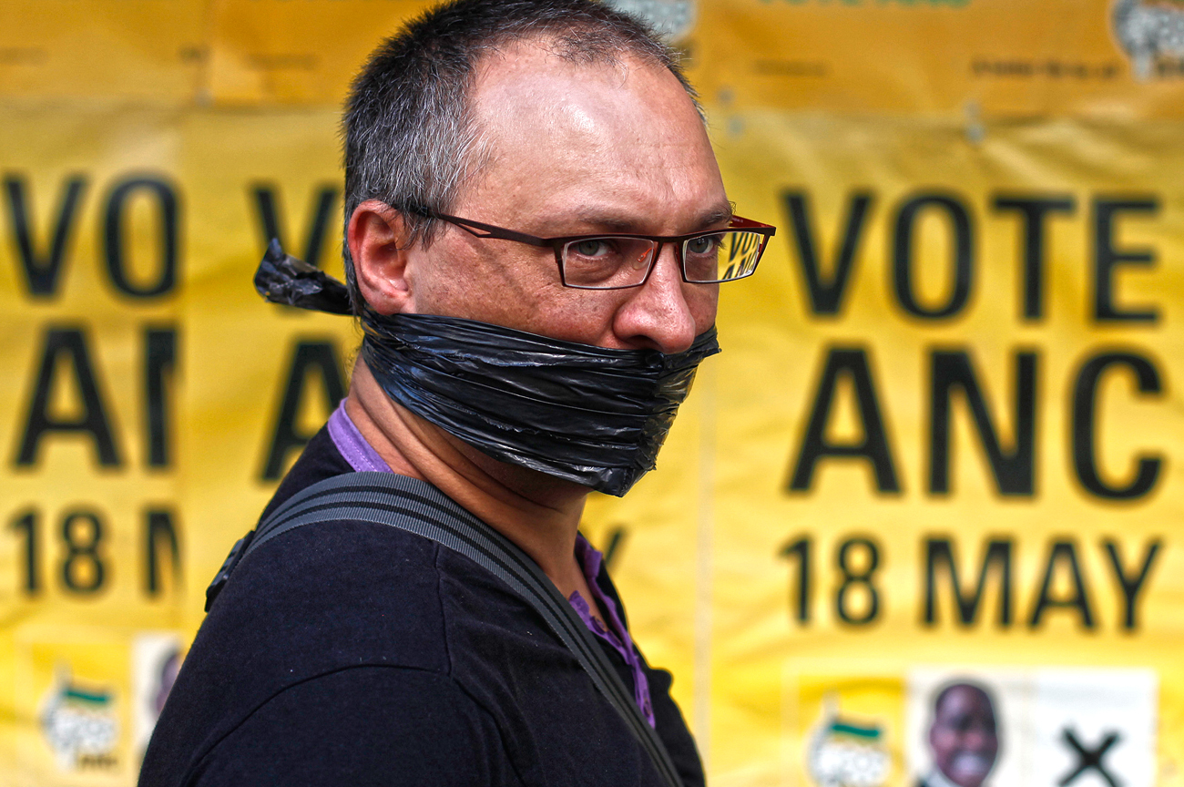 A protester looks on outside the ruling ANC headquarters, during a protest against the passing of new laws on state secrets in Johannesburg