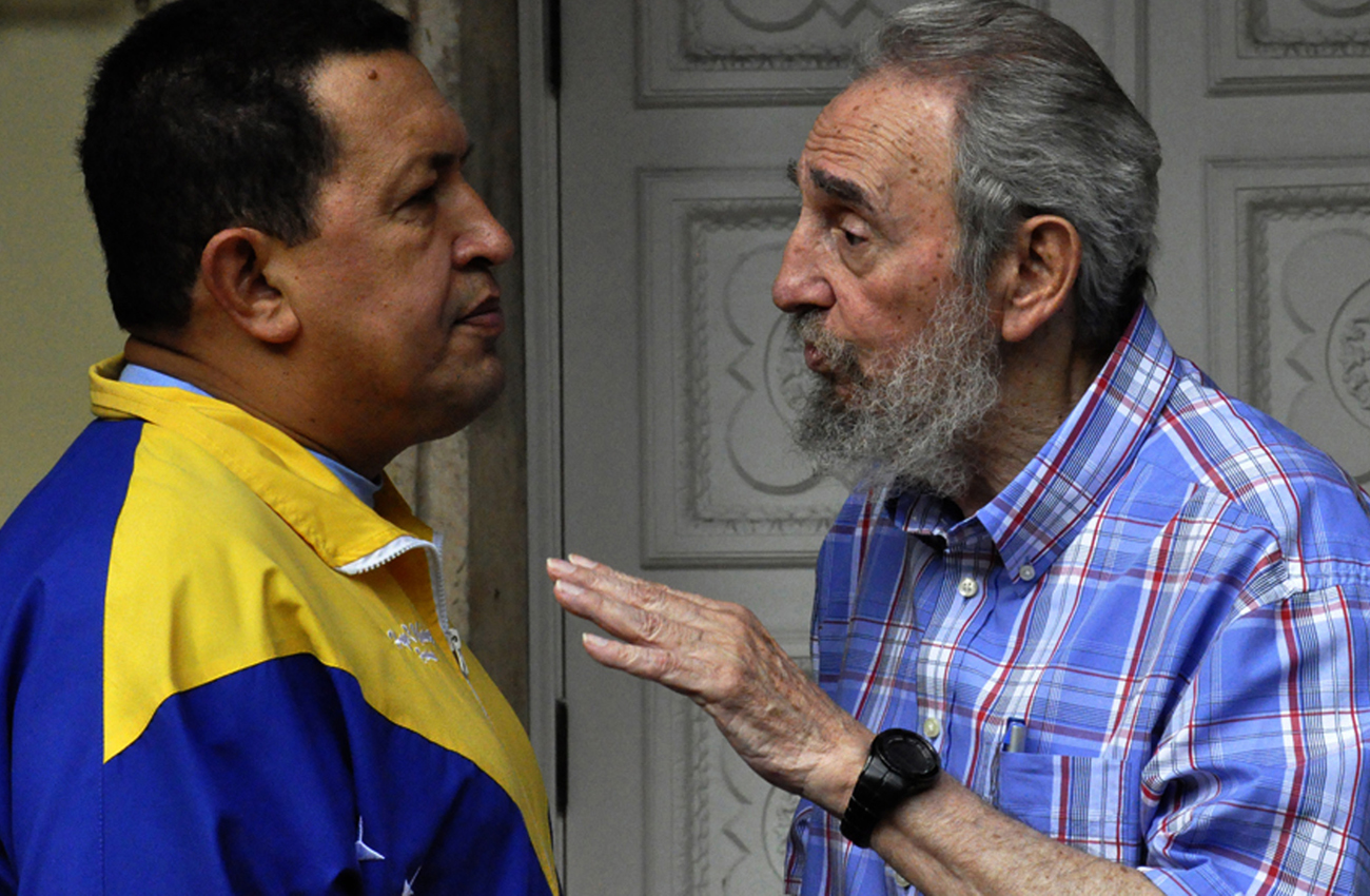 Former Cuban leader Castro and Venezuelan President Chavez talk during a meeting in Havana