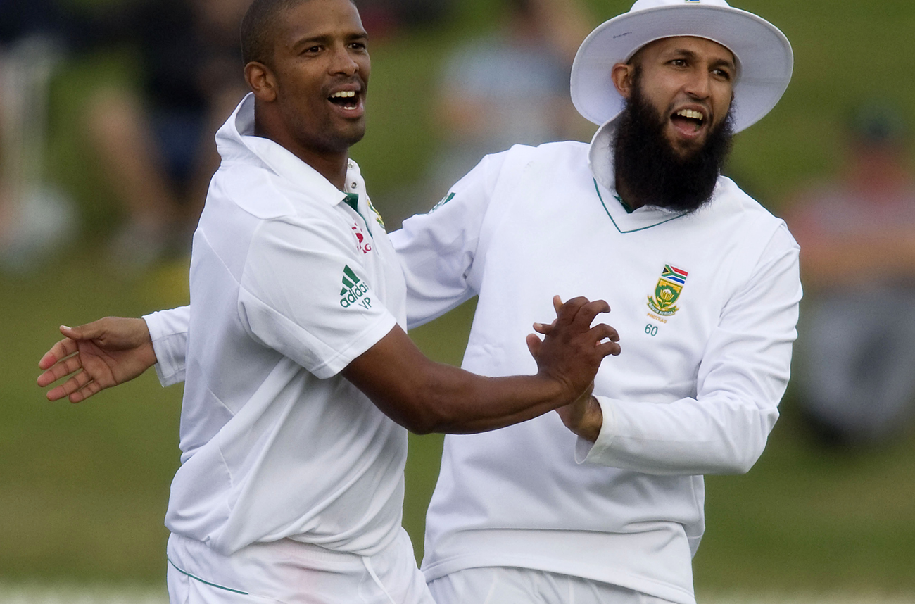 South Africa's Vernon Philander celebrates with Hashim Amla after dismissing Ross Taylor on day one of the second international cricket test match against New Zealand, in Hamilton