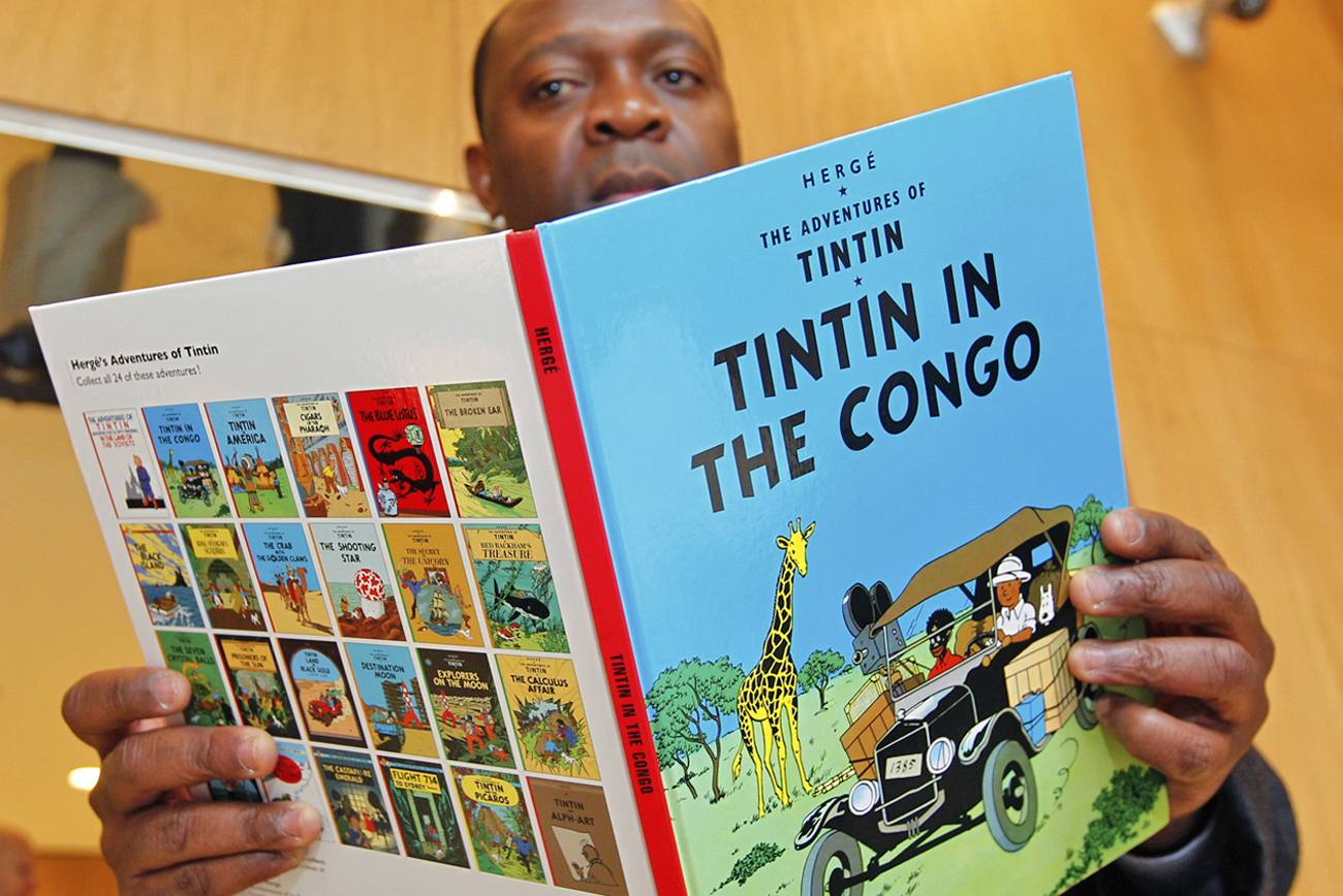 Congolese-born Bienvenu Mbutu Mondondo holds the "Tintin in Congo" comics ahead of hearing at Palace of Justice in Brussels