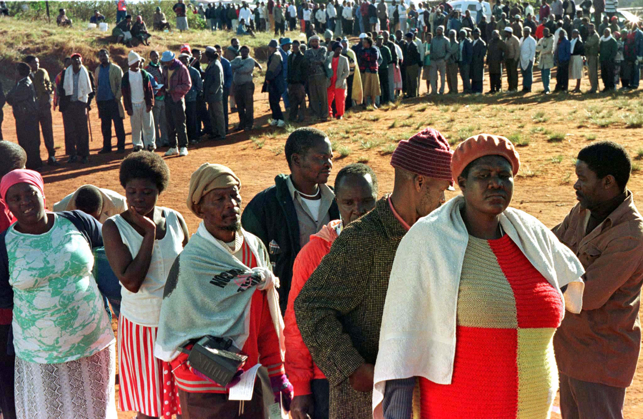 Residents of this black township south of Durban queue outside a polling station June 26. South Afri..