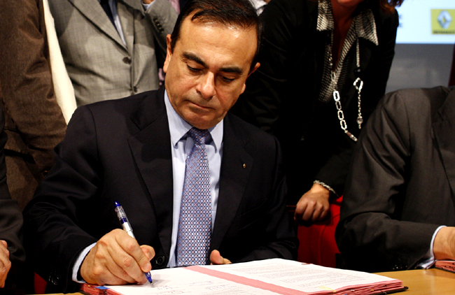Renault SA Chief Executive Ghosn and French Industry Minister Estrosi sign an agreement during a visit at the Renault car factory in Flins