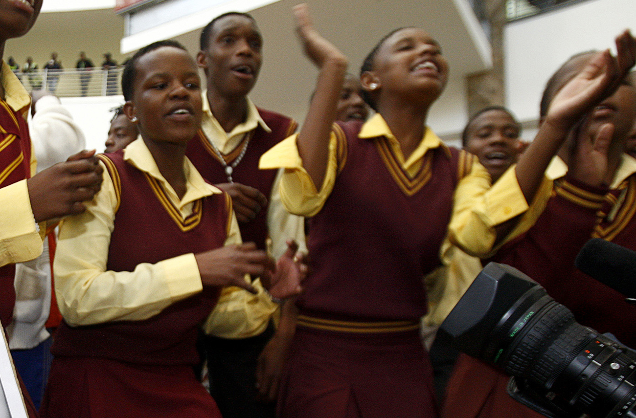 School children sing as they wait to welcome South Africa's teenage 800 metres world champion Caster Semenya at the O.R Tambo international airport in Johannesburg