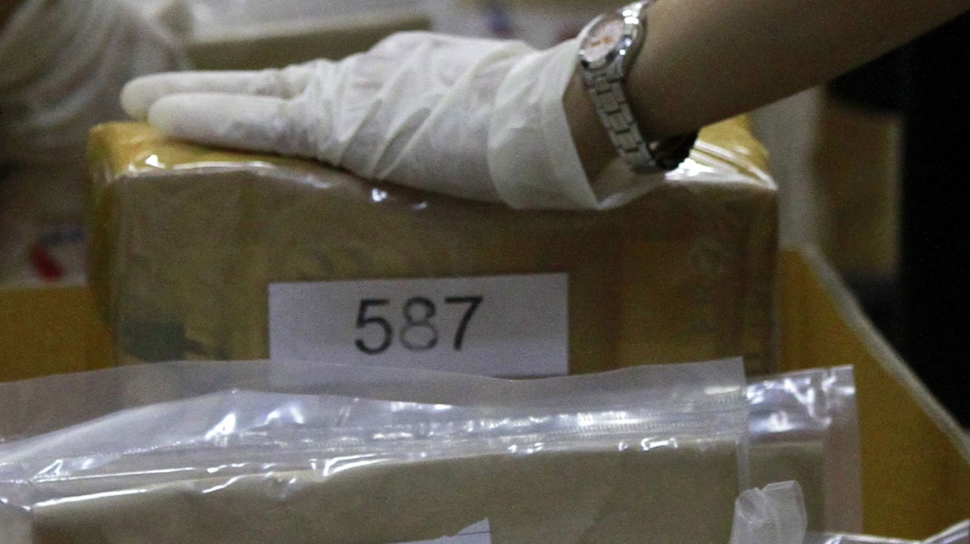 Thai narcotics officials check boxes of confiscated drugs that will be destroyed on Friday, in Bangkok