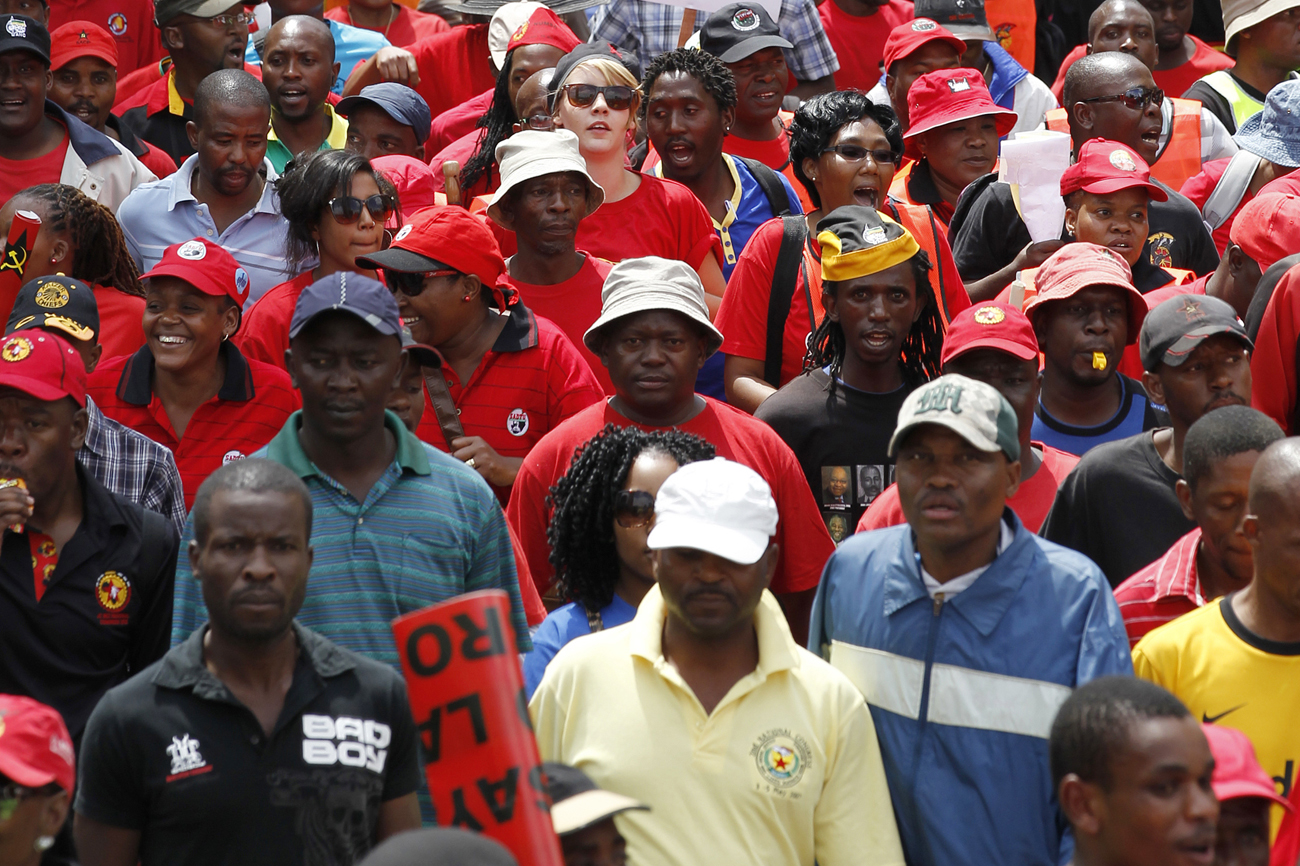 Supporters of  the Congress  of South African Trade Unions (COSATU) take part in a march in the streets of Johannesburg
