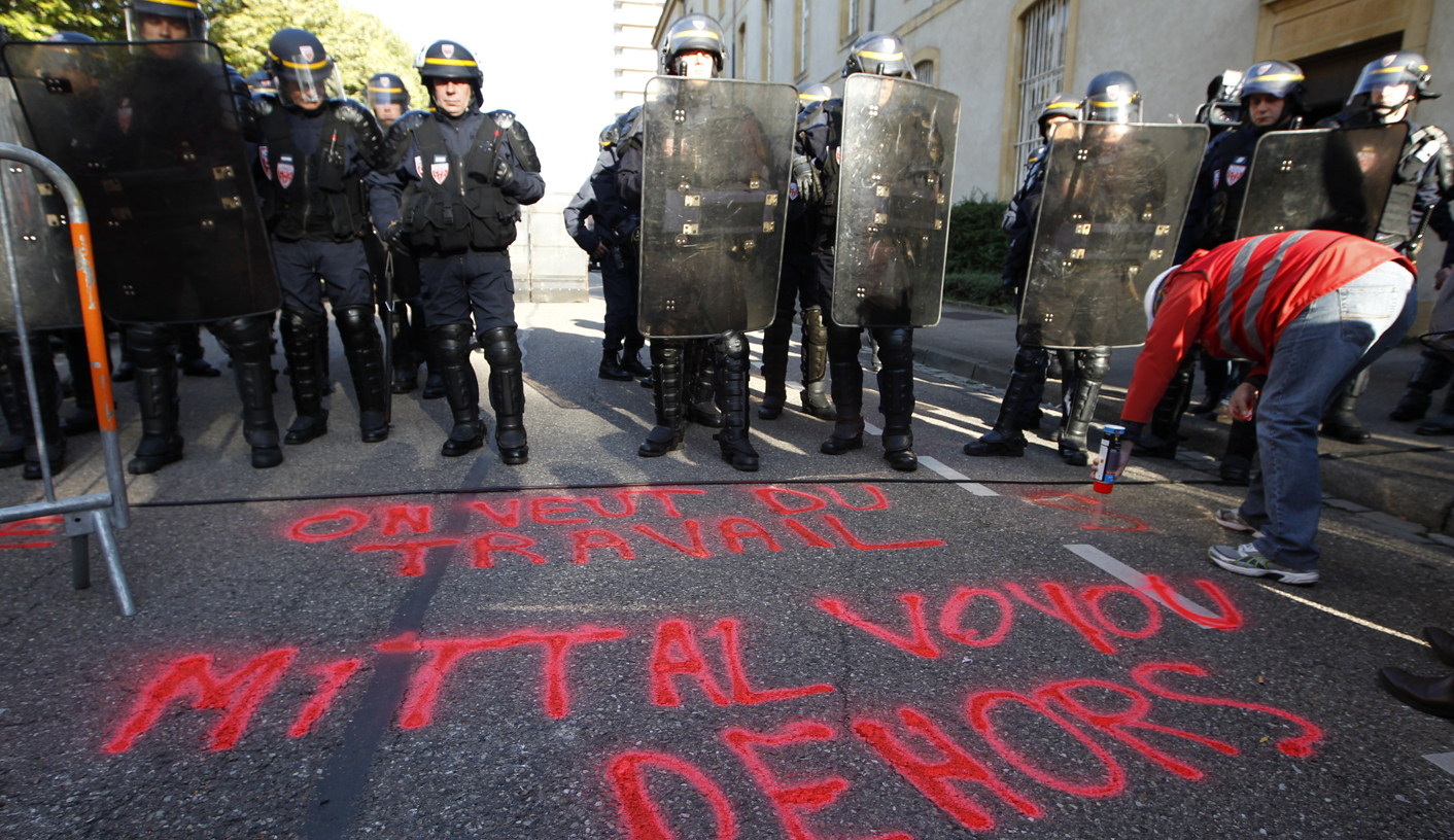 ArcelorMittal workers from Florange face French CRS riot police as they demonstrate during the company's works council meeting in Metz