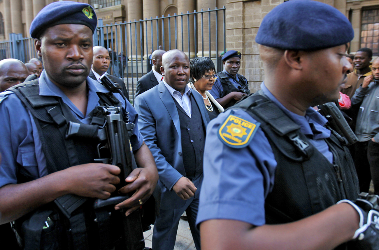 ANCYL President Malema is escorted after appearing at the Johannesburg court
