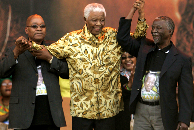 Former South African president Mandela smiles as he arrives with ANC president Zuma and South Africa's president Mbeki at the Loftus stadium in Pretoria