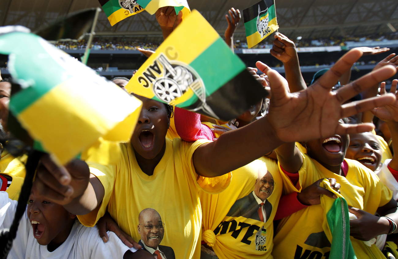 Supporters of the ruling party African National Congress (ANC) cheer during their final rally in Soweto