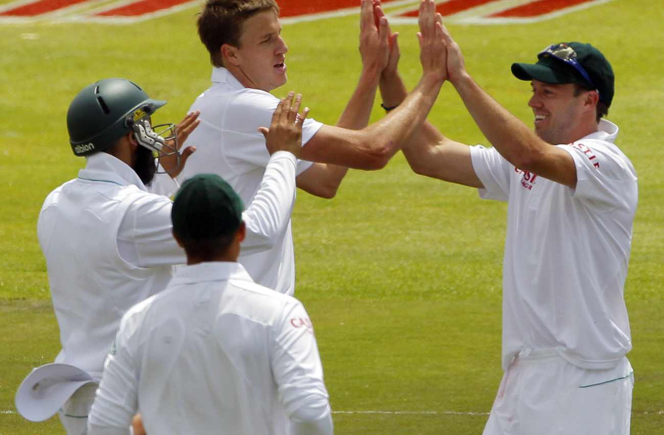 South Africa's Morkel celebrates with team-mates after he took wicket of Australia's Siddle during second day of their first test match in Cape Town